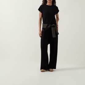 Model wearing Joseph Ribkoff Wide Leg Scuba Trousers in black with elasticated waist, styled with black tee and khaki tied jacket.