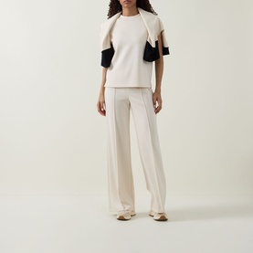 Model wearing Joseph Ribkoff Wide Leg Scuba Trousers in Birch with matching knit top and draped jacket with black contrast sleeves.