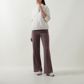 Model wearing Joseph Ribkoff Mink trousers in flared silhouette, styled with cream zip-up top and grey trainers.