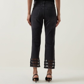 Model wearing Joseph Ribkoff Rhinestone Hem Jeans in Charcoal Grey, cropped skinny fit with lattice rhinestone hem detail, styled with black heels.