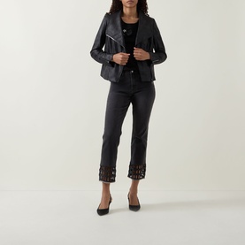 Model wearing Joseph Ribkoff Rhinestone Hem Jeans in charcoal grey, cropped skinny fit with rhinestone trim, styled with a black leather jacket and