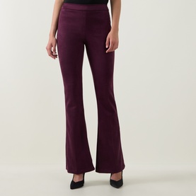 Model wearing Joseph Ribkoff elderberry flared trousers in stretch fabric, styled with black pointed-toe heels.