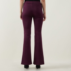 Model wearing Joseph Ribkoff Trousers in Elderberry, rear view showing flared leg silhouette and smooth fitted finish.