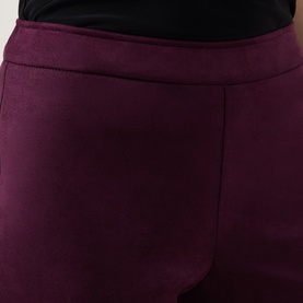 Model wearing Joseph Ribkoff Trousers in elderberry, close-up of smooth stretch fabric waistband and hip detail.