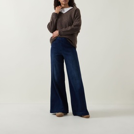 Model wearing Joseph Ribkoff dark denim blue wide-leg trousers, styled with a brown knit jumper and white shirt.