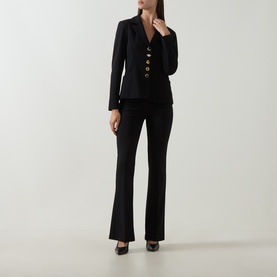 Model wearing Joseph Ribkoff black flared trousers with black blazer featuring gold buttons and black heels.
