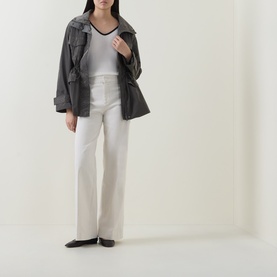 Model wearing Joseph Ribkoff High-Rise Wide Leg Jeans in Birch with pressed creases, styled with grey utility jacket and black flats.