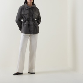 Model wearing Joseph Ribkoff High-Rise Wide Leg Jeans in Birch, styled with a dark grey utility jacket and black flat shoes.