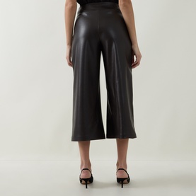 Model wearing Joseph Ribkoff Faux Leather Culottes Trousers in Mocha, wide-leg cropped silhouette, pull-on style, paired with black heeled mules.