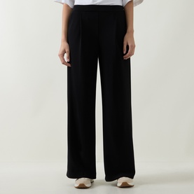 Model wearing Joseph Ribkoff Tailored Wide Leg Trousers in black, featuring pleated details and wide-cut legs, styled with a white top and beige