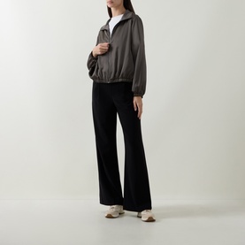 Model wearing Joseph Ribkoff Tailored Wide Leg Trousers in black with wide-cut legs, styled with a dark zip-up jacket and white tee.