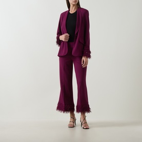 Model wearing Joseph Ribkoff Feather-Trim Cropped Trousers in Berry Burst with matching feather-trim blazer and strappy heels.