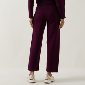 Model wearing Joseph Ribkoff Brushed Knit Track Pants in Elderberry, straight-cut legs, elasticated waist, styled with matching knit top and white
