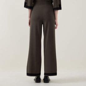 Model wearing Joseph Ribkoff Trousers in Avocado/Black, wide-leg knit style with contrast black trim, rear view, styled with matching top.