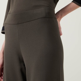 Model wearing Joseph Ribkoff trousers in avocado green with elasticated waistband, styled with matching top.