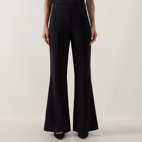 Model wearing Joseph Ribkoff black wide-leg flared trousers with a high waist and sleek silhouette, styled with black heels.