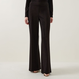 Model wearing Joseph Ribkoff bronze wide-leg trousers in metallic fabric, styled with a black long-sleeve top and gold heels.