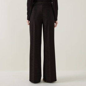 Model wearing Joseph Ribkoff bronze wide-leg trousers in metallic shimmer fabric, rear view, styled with a dark long-sleeve top.
