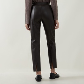 Model wearing Joseph Ribkoff Bonded Faux Leather Trousers in Mocha, straight-cut with notched back cuffs, styled with black loafers.