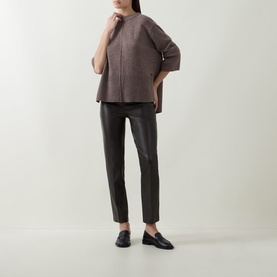 Model wearing Joseph Ribkoff Bonded Faux Leather Trousers in Mocha with straight-cut legs and notched cuffs, styled with a brown top and black