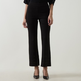 Model wearing Joseph Ribkoff Embellished Flared-Leg Trousers in black, mid-rise pull-on style, styled with black heels