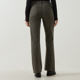 Model wearing Joseph Ribkoff Slim-Leg Jeans in Avocado, rear view showing straight-leg silhouette and five-pocket styling, styled with black top and