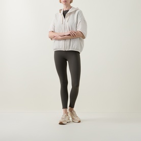 Model wearing Joseph Ribkoff Avocado trousers in slim-fit style, styled with a light zip-up jacket and cream trainers.