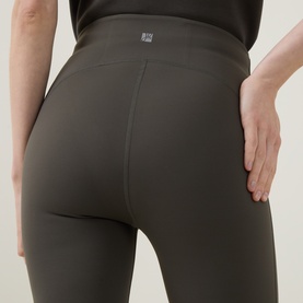 Model wearing Joseph Ribkoff trousers in avocado, close-up rear view showing high waistband and smooth nylon-spandex fabric fit.