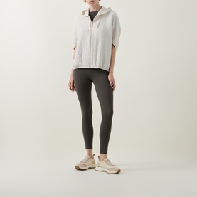 Model wearing Joseph Ribkoff Trousers in Avocado, styled with a cream zip-up top and beige chunky trainers.