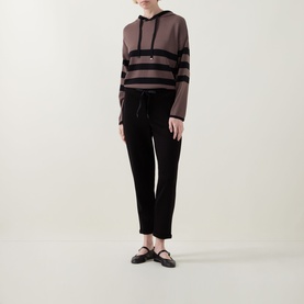 Model wearing Joseph Ribkoff black trousers with drawstring waist, styled with a striped hoodie and black flat shoes.