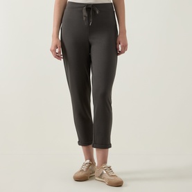 Model wearing Joseph Ribkoff Drawstring Cropped Sweatpants in Avocado, elasticated waist, straight leg, styled with beige trainers.