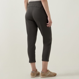 Model wearing Joseph Ribkoff Drawstring Cropped Sweatpants in Avocado, shown from behind with elasticated waist and straight-leg cropped fit.