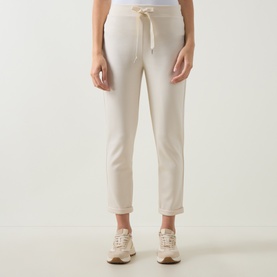 Model wearing Joseph Ribkoff Drawstring Cropped Sweatpants in Birch, elasticated waist, straight leg, styled with beige trainers