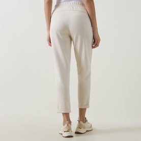 Model wearing Joseph Ribkoff Drawstring Cropped Sweatpants in Birch, rear view, elasticated waist, straight leg, styled with white trainers