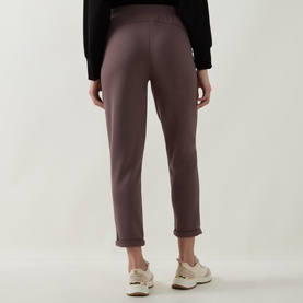 Model wearing Joseph Ribkoff Drawstring Track Pants in Mink, shown from behind, with rolled cuffs and elasticated waistband. Styled with white