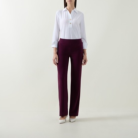 Model wearing Joseph Ribkoff elderberry straight-leg trousers, styled with a white shirt and cream heels.