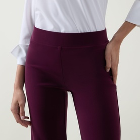 Model wearing Joseph Ribkoff Trousers in elderberry, close-up of high-rise waistband and side pockets, styled with white shirt.