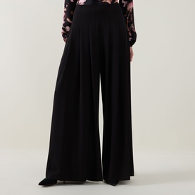 Model wearing Joseph Ribkoff black wide-leg palazzo trousers, styled with a floral print blouse.