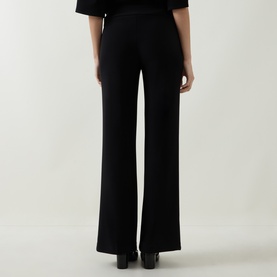 Model wearing Joseph Ribkoff black wide-leg trousers in polyester-spandex blend, shown from behind, styled with black heels.