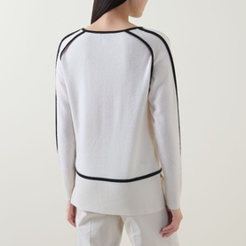 Model wearing Joseph Ribkoff Tunic in Winter White with black contrast trim detail, back view, paired with white trousers.