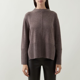 Model wearing Joseph Ribkoff Button Knit Sweater in Mink Melange, crew neck, long sleeves, high-low hemline, styled with black trousers