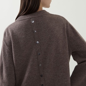 Model wearing Joseph Ribkoff Button Knit Sweater in Mink Melange, showing back button detailing on mink-toned wool knit