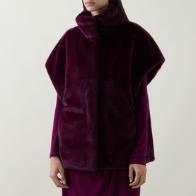 Model wearing Joseph Ribkoff Elderberry faux fur vest with funnel neck, styled with matching wide-leg trousers