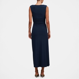 Model wearing Forever New Evening Navy sleeveless midi dress with ruched waist detail, styled with brown heeled mules, back view.