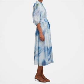 Model wearing Forever New midi dress in Bluewater Abstract print, featuring puff sleeves, belted waist, and flared skirt, styled with brown heeled