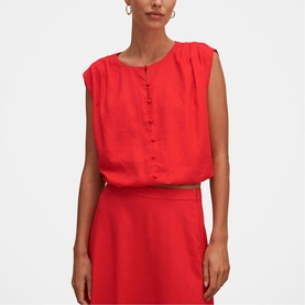 Model wearing Forever New Cherry Tomato sleeveless button-front blouse, styled with matching red midi skirt and gold belt.