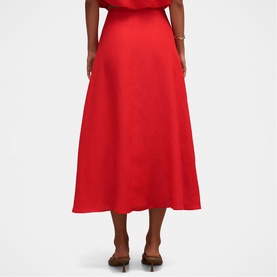 Model wearing Forever New Cherry Tomato midi skirt with flared silhouette, styled with matching top and brown heeled mules.