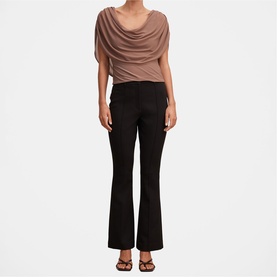 Model wearing Forever New Portobello cowl-neck draped top, styled with black flared trousers and black heeled sandals.