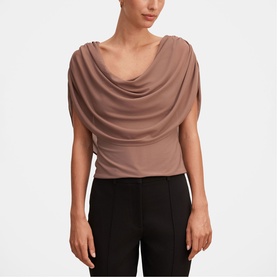 Model wearing Forever New Portobello draped cowl-neck top with short sleeves, styled with black trousers.