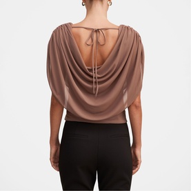 Model wearing Forever New Portobello draped back top with tie detail, styled with black trousers. Back view.